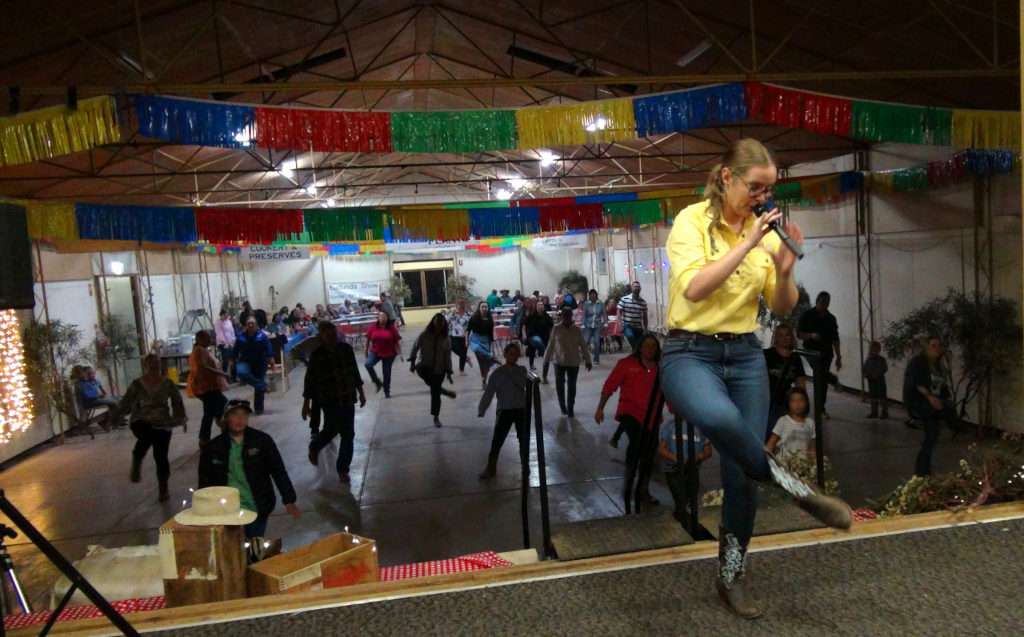 Claire instructing the keen dancers from the stage