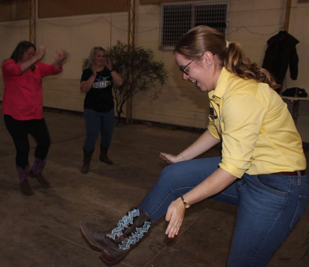 Claire shows leg clap with Carmen Jonas & Leyanne Jolly behind